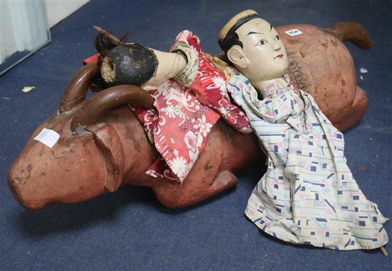 A carved Vietnamese pig and two Chinese hand puppets
